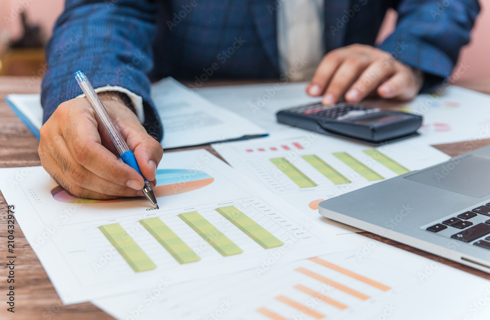Businessman taking notes and checking data Businessman taking notes and checking data
