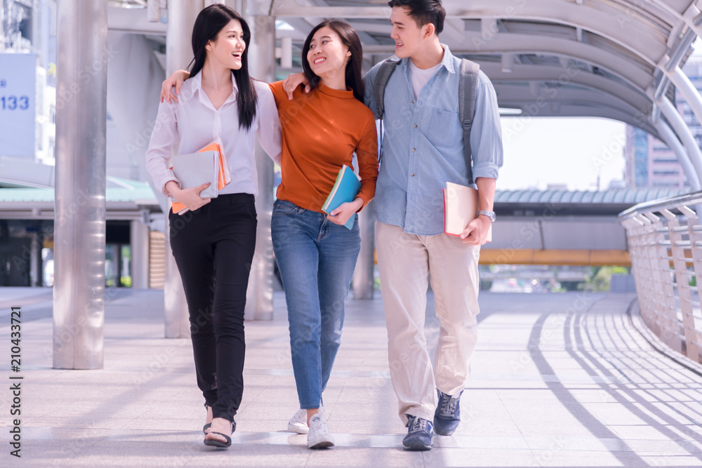 Front view of three asian students walking and talking in an university  campus. Stock Photo | Adobe Stock