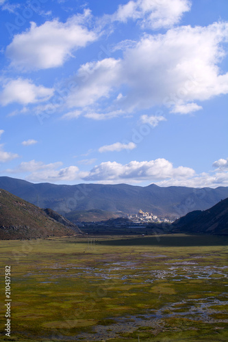 Wetland in valley with mountain background at Shangri La, China © pomiti