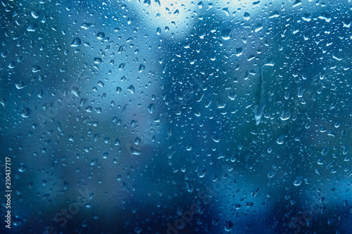 Blue freshness after the rain. The texture of the drops on the glass.