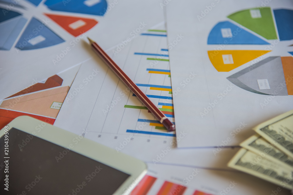 Laptop with financial documents on wooden table Laptop with financial documents on wooden table