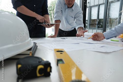 architect working on real estate project with partner at workplace. engineer discussing on living house blueprint at office. construction & building concept