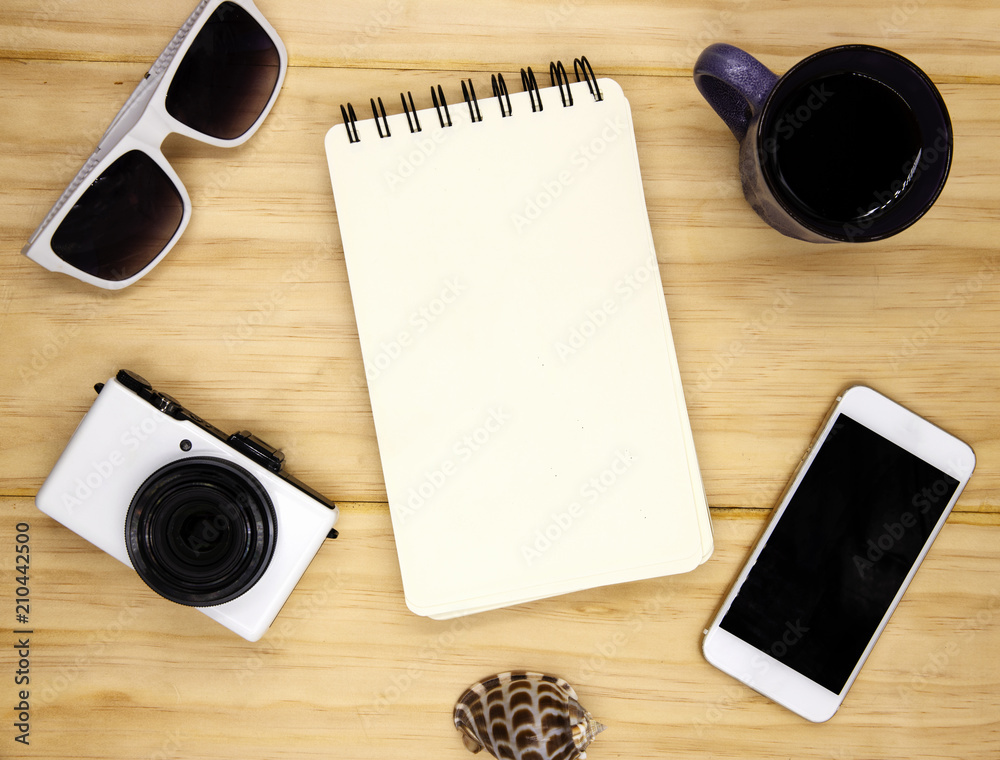 Blank page of spiral notepad on wooden table. Summer travel flat lay photo. Empty sketchbook page on table top view Blank page of spiral notepad on wooden table. Summer travel flat lay photo. Empty sketchbook page on table top view
