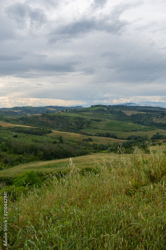Bewölkter Himmel in der Toskana mit grünem Feld