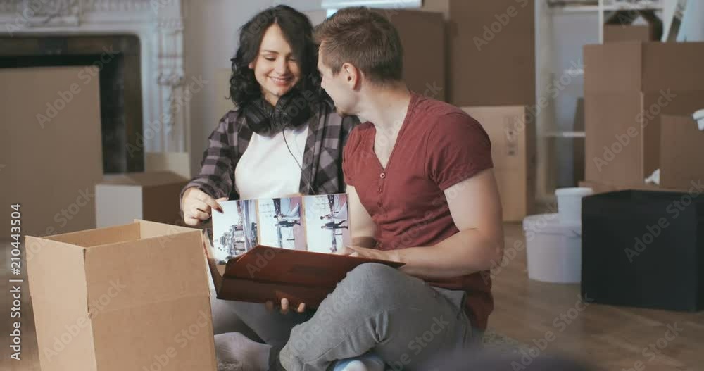 Future parents enjoying a memory in new apartment Future parents enjoying a memory in new apartment
