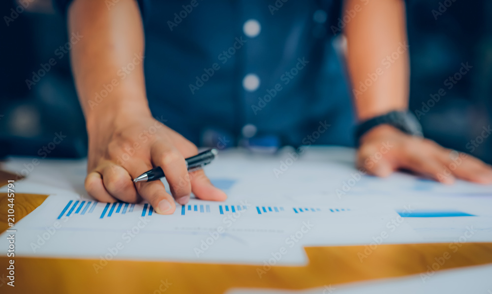 Hands of Businessman working on Laptop Computer with Data Charts Hands of Businessman working on Laptop Computer with Data Charts