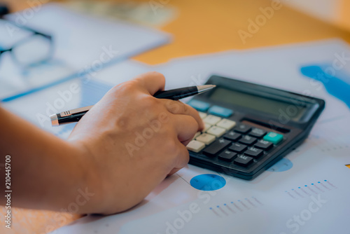 business man financial inspector and secretary making report, calculating or checking balance. Internal Revenue Service inspector checking document. Audit concept.