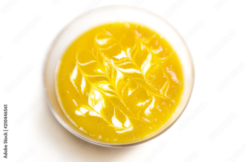 Pumpkin soup with cream on white background Pumpkin soup with cream on white background