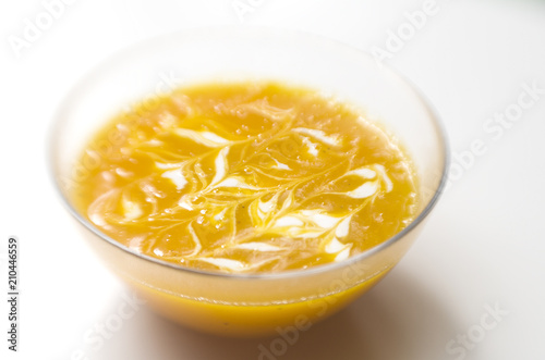 Pumpkin soup with cream on white background
