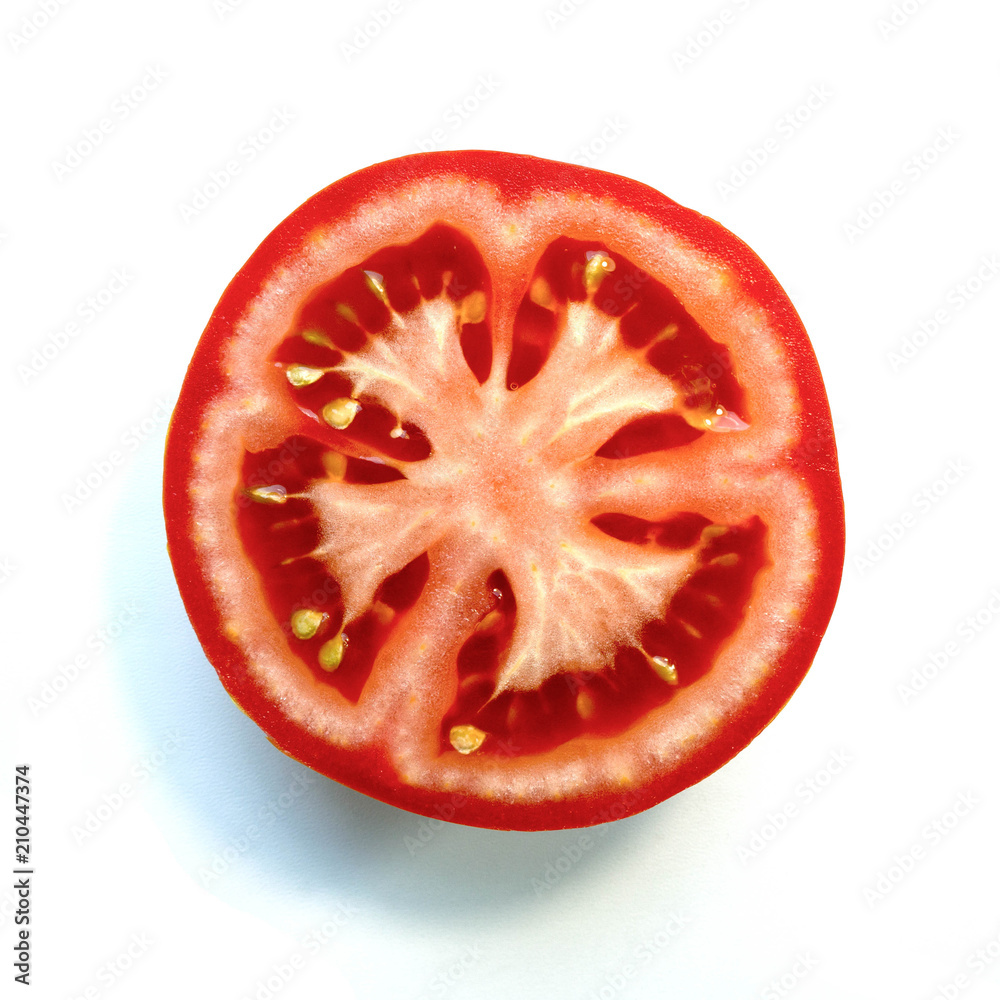 Ripe red tomato in a section on a white background. Ripe red tomato in a section on a white background.