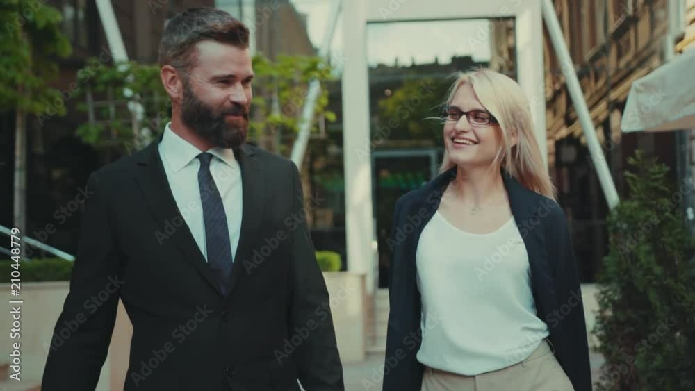 Portrait business man and woman talking walking smiling together at outdoor happy handsome internet technology pair team corporate executive city outside urban work young teamwork worker Portrait business man and woman talking walking smiling together at outdoor happy handsome internet technology pair team corporate executive city outside urban work young teamwork worker