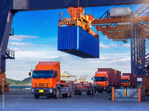 Industrial port crane lift up loading export containers box onboard from truck at port of Thailand,The port crane type's twinlift is the best solution for port operations. photo