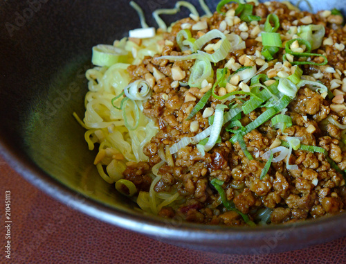 Chinese food, Dan Dan Noodles with pork, scallions and peanuts in bowl photo