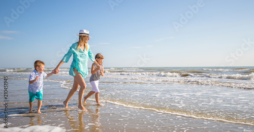Sticker beautiful mom play with her children in the sea