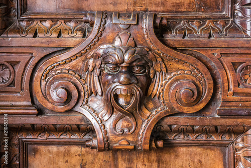 Door wood carving decoration mask in Palazzo Ducale, Venice, Italy