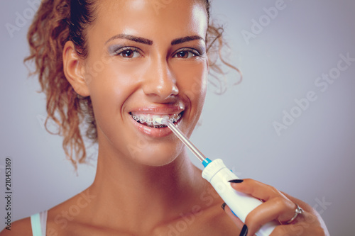 Brushing Teeth With Tooth Irrigator
