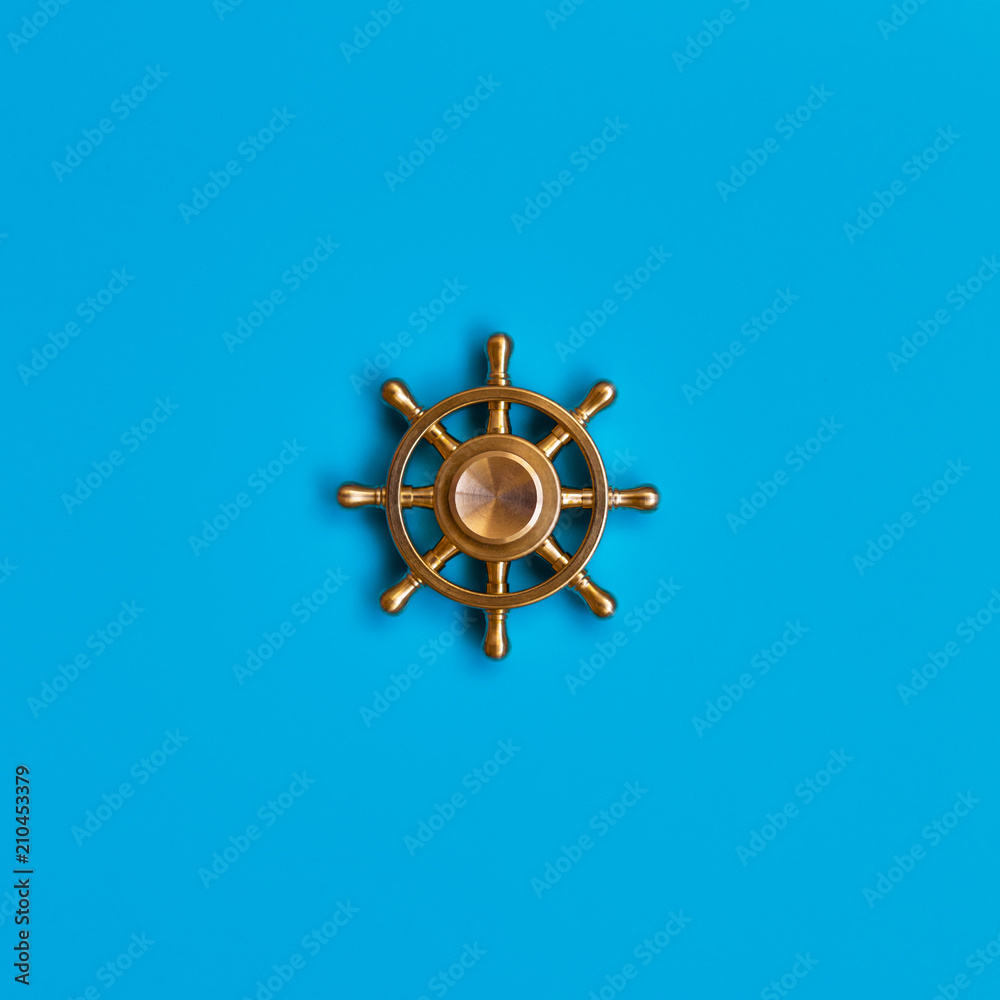 Obraz premium Ship's wheel on blue background. Symbol of management and leadership.