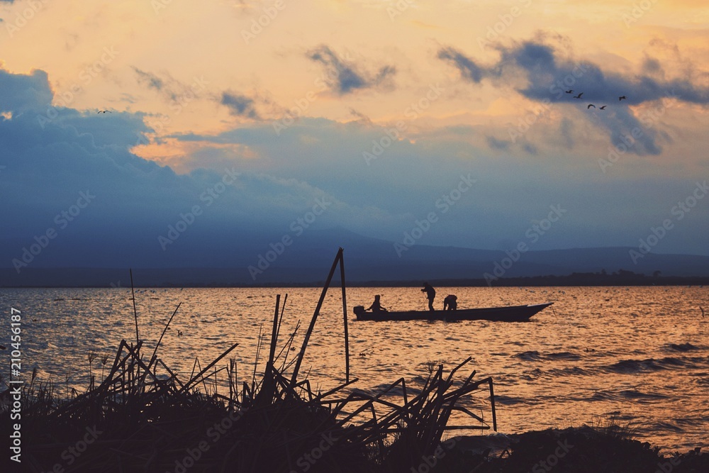 Fishing boat against a golden sunset at Lake Naivasha, Kenya