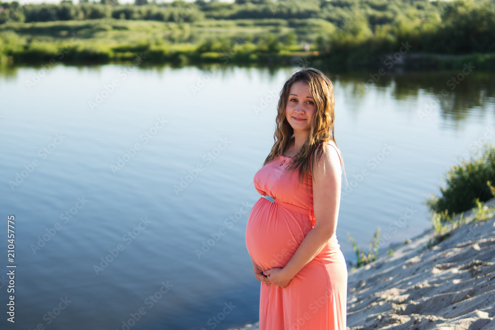 Happy pregnant woman nature with copyspace Happy pregnant woman nature with copyspace