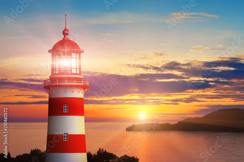 Lighthouse light and sunset at the sea coast