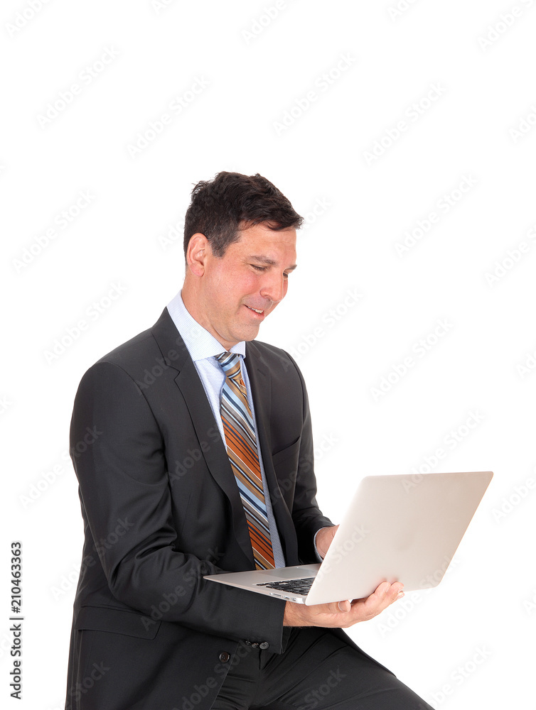 Happy businessman sitting with his laptop Happy businessman sitting with his laptop