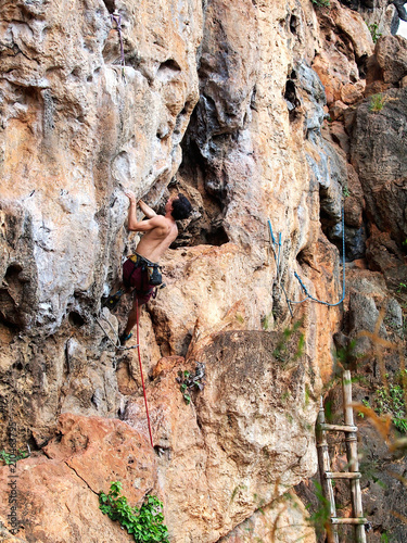 Young strong guy climbing / leading topless in Thailand - Krabi, Tonsai Beach