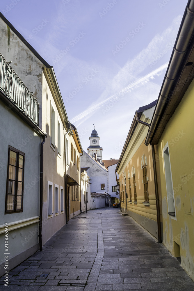 Narrow colorful Town Street with Church Tower in the Background