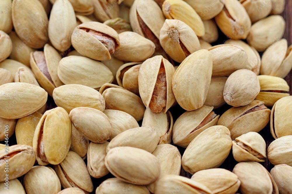 Pistachios nuts on wooden table. Pistachios nuts on wooden table.