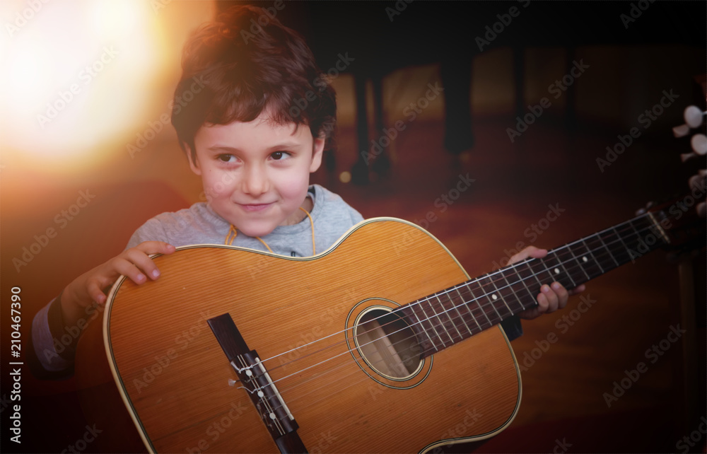 Obraz premium Child playing guitar. Learning concept. 