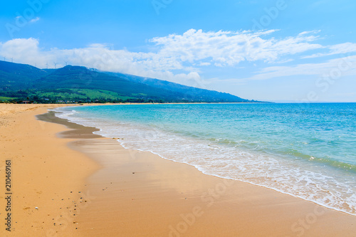 Bild auf Leinwand Sandy Paloma beach and mountains in background, Costa de la Luz, Spain