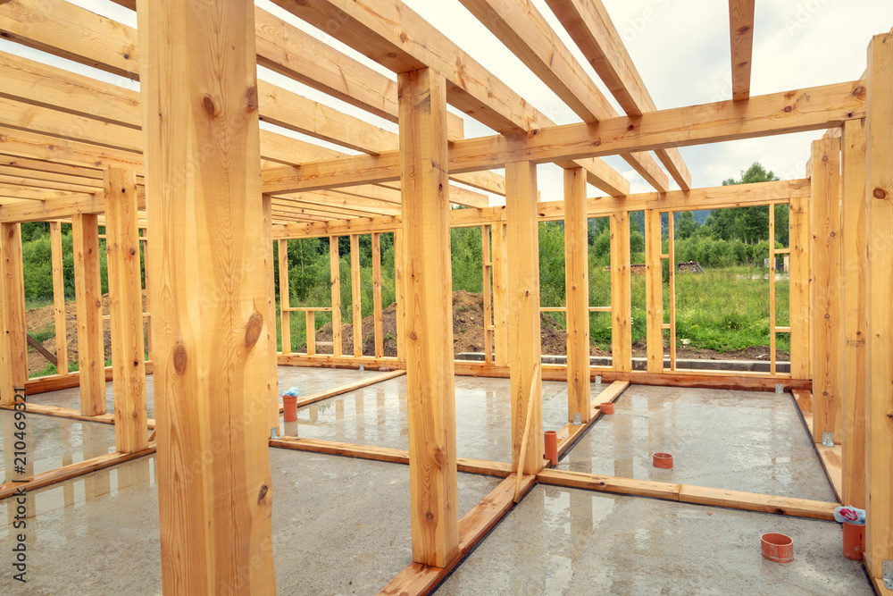 Wooden construction of an unfinished house. Skeleton of a building made of beams. Wooden construction of an unfinished house. Skeleton of a building made of beams.