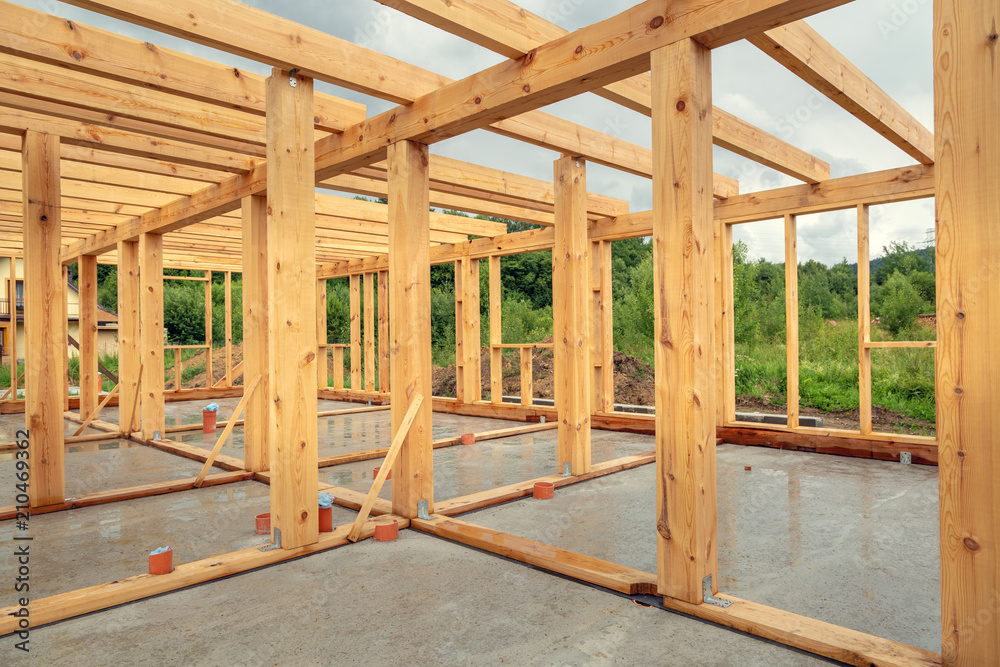 Wooden construction of an unfinished house. Skeleton of a building made of beams. Wooden construction of an unfinished house. Skeleton of a building made of beams.