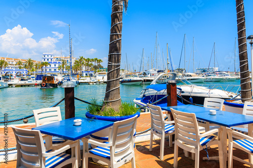 Tables of traditional restaurant in Estepona port on Costa del Sol coast, Spain