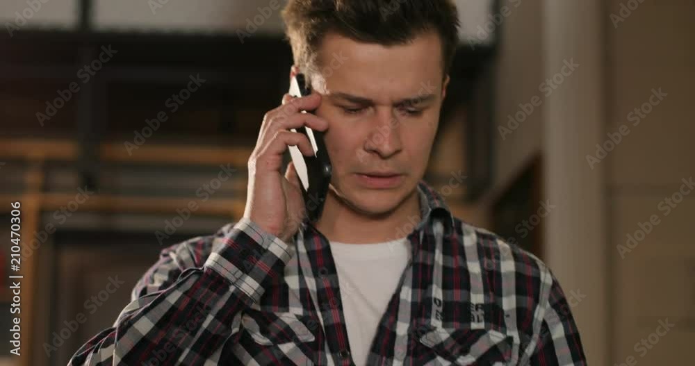 Handsome man using smartphone in the office, coworking area Handsome man using smartphone in the office, coworking area