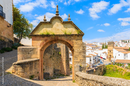 Castle gate and view of white houses in Andalusian village of Ronda, Spain