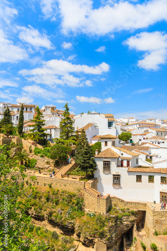 Church building on square and white houses in Andalusian village of Ronda, Spain