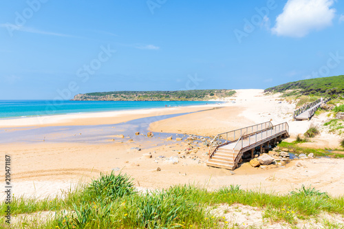 Wooden footbridge on sandy Bolonia beach on southern coast of Spain near Tarifa town