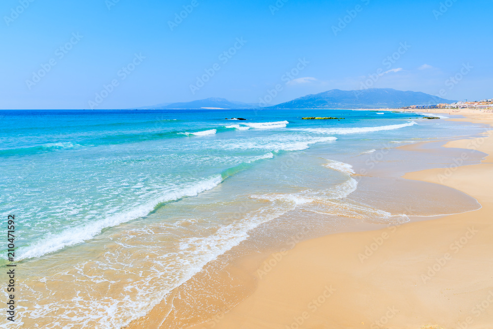 Sea waves on sandy Tarifa beach, Andalusia, Spain