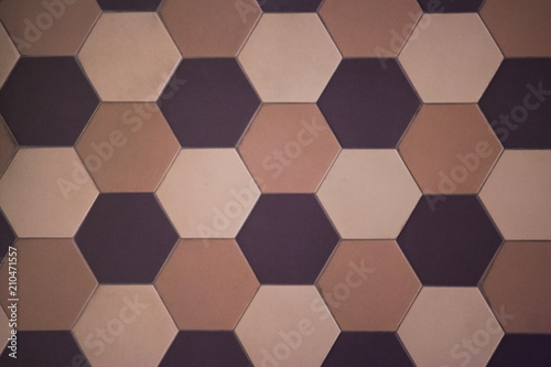 Hexagonal tiles on the wall or floor of a warm color scheme. Modern, fashionable tiles are often used in modern interiors