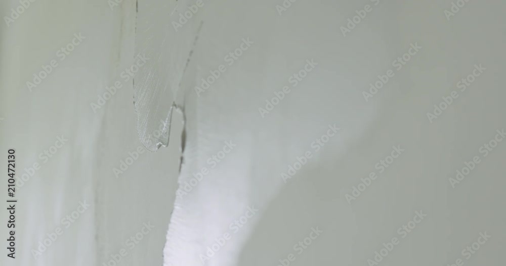 Slow motion closeup worker applying decorative concrete plaster on the wall Slow motion closeup worker applying decorative concrete plaster on the wall