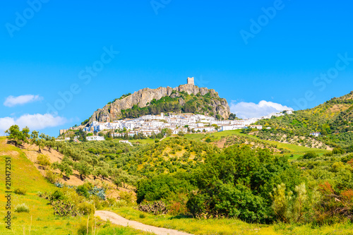 White village of Zahara de la Sierra on green hills at spring time, Andalusia, Spain