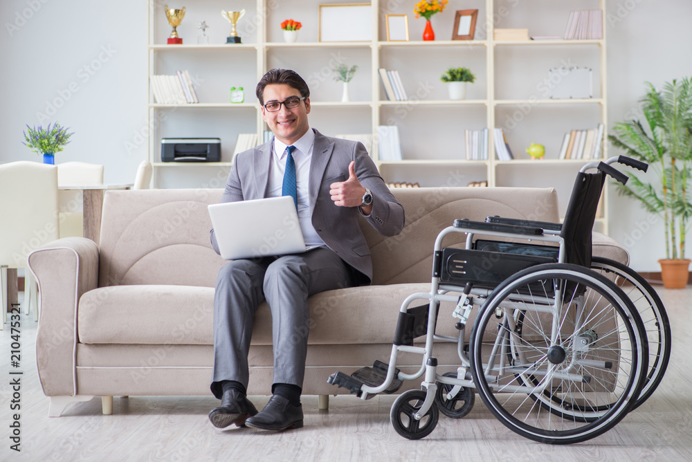 Dsabled businessman on wheelchair working home Dsabled businessman on wheelchair working home