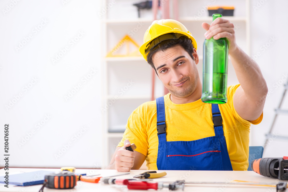 Drunk engineer working in the workshop Drunk engineer working in the workshop