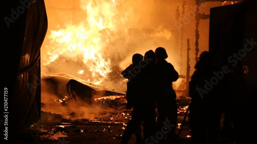 Firefighters Spraying Water Onto Fully Engulfed Building Slow Motion 4K
