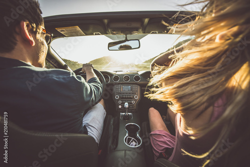 Couple driving on a convertible car