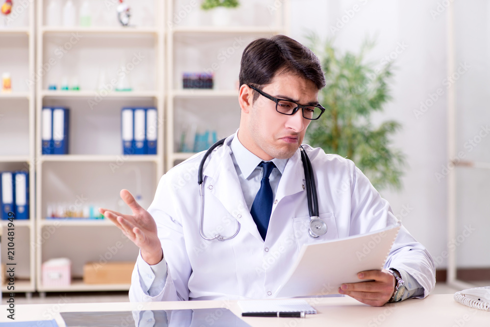 Young doctor sitting in the office Young doctor sitting in the office
