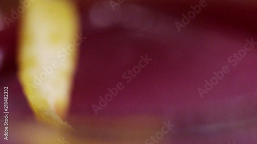 Pouring pink cocktail into a glas with ice (Red.Cinema) (Slowmo)