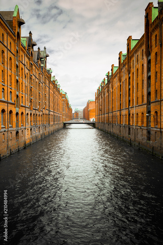 channel with old buildings made of bricks at the HafenCity in Hamburg