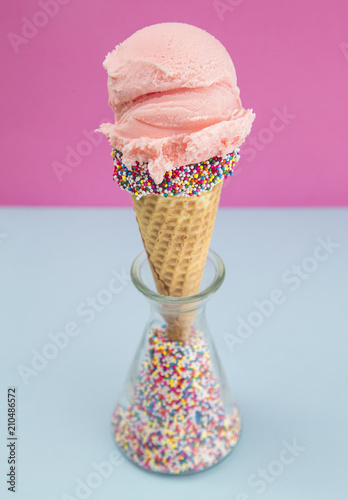 Strawberry Ice Cream in a Waffle Cone with Sprinkles