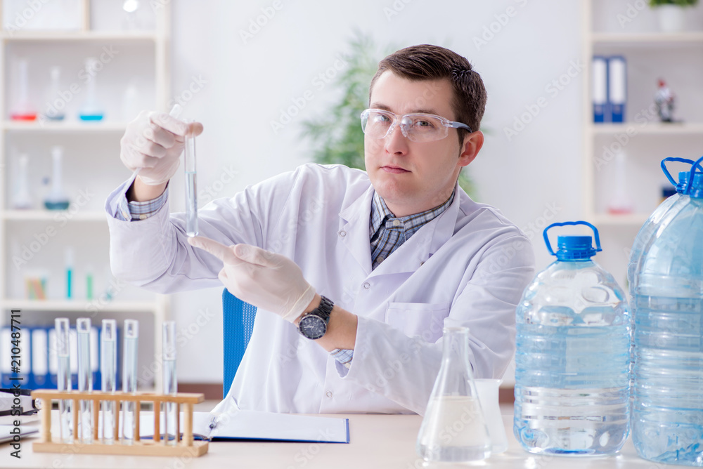 Fototapeta premium Young chemist student experimenting in lab